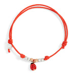 Load image into Gallery viewer, Bracciale Pad Mini Coccinella DoDo con charm coccinella in oro rosa 9K smaltata, mini granelli in argento e oro, cordino rosso regolabile.

