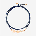 Load image into Gallery viewer, Bracciale Stellina DoDo in oro rosa 9K con cordino in cotone blu, simbolo di fortuna e sogni sotto le stelle.
