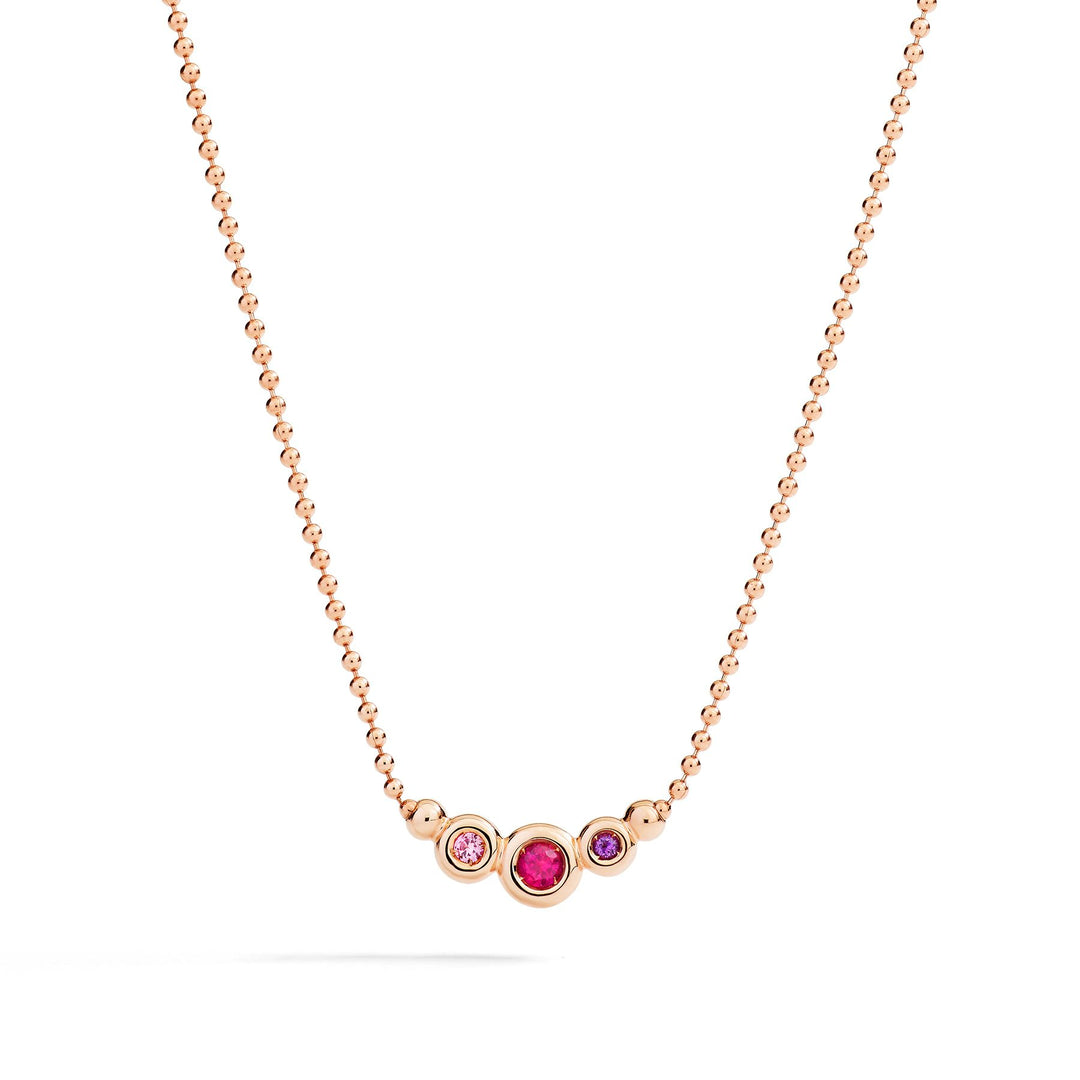 Gioiello collana unisex in oro rosa con pietre preziose colorate, simbolo di eleganza e vitalità.